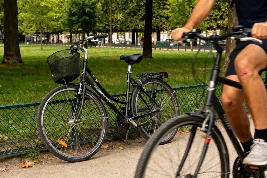 Cycliste blessé pédalant dans un parc sur un vélo avec un kyste poplité visible